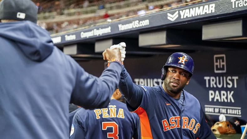 Apr 22, 2023; Cumberland, Georgia, USA; Houston Astros designated hitter Yordan Alvarez (44) reacts in the dugout with manager Dusty Baker (12) after hitting a two run home run against the Atlanta Braves during the sixth inning at Truist Park. Mandatory Credit: Dale Zanine-USA TODAY Sports