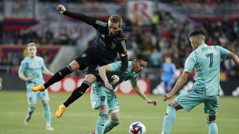 Apr 22, 2023; Sandy, Utah, USA; San Jose Earthquakes midfielder Jackson Yueill (14) challenges Real Salt Lake defender Bryan Oviedo (3) in the first half at America First Field. Mandatory Credit: Jeffrey Swinger-USA TODAY Sports
