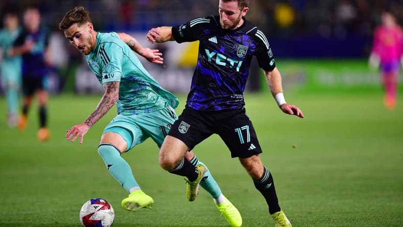 Apr 22, 2023; Carson, California, USA; Los Angeles Galaxy midfielder Tyler Boyd (11) moves the ball against Austin FC forward Jon Gallagher (17) during the first half at Dignity Health Sports Park. Mandatory Credit: Gary A. Vasquez-USA TODAY Sports