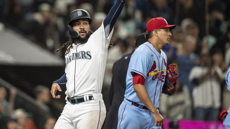 Apr 22, 2023; Seattle, Washington, USA; Seattle Mariners shortstop J.P. Crawford (3) gestures to third baseman Eugenio Suarez (28) after scoring a run during the seventh inning against the St. Louis Cardinals at T-Mobile Park. Mandatory Credit: Stephen Brashear-USA TODAY Sports