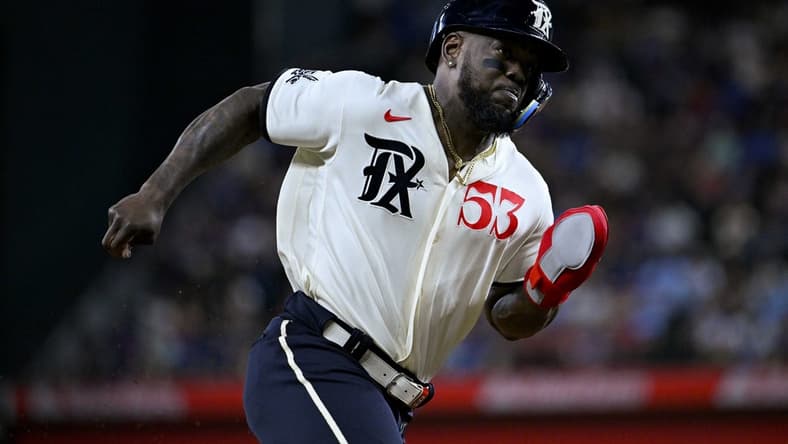 Apr 22, 2023; Arlington, Texas, USA; Texas Rangers right fielder Adolis Garcia (53) scores against the Oakland Athletics during the game at Globe Life Field. Mandatory Credit: Jerome Miron-USA TODAY Sports