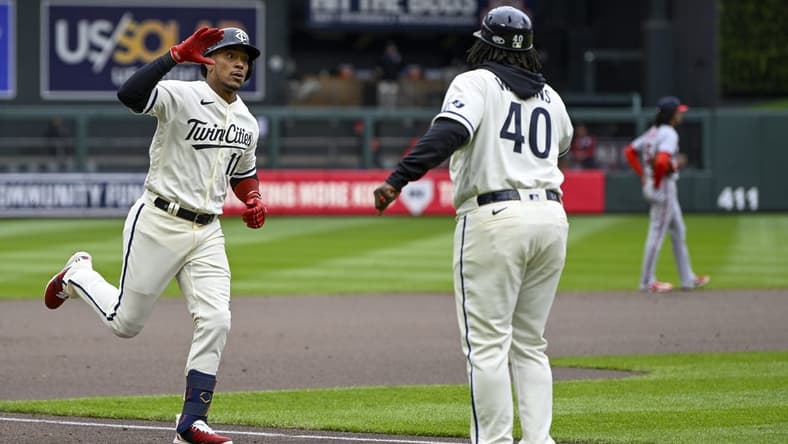 Apr 23, 2023; Minneapolis, Minnesota, USA;  Minnesota Twins infielder Jorge Polanco (11) celebrates his solo home run against the Washington Nationals with third base coach Tommy Watkins (40) during the fourth inning at Target Field. Mandatory Credit: Nick Wosika-USA TODAY Sports