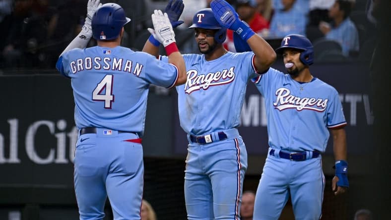 Apr 23, 2023; Arlington, Texas, USA; Texas Rangers designated hitter Robbie Grossman (4) and center fielder Leody Taveras (3) and second baseman Marcus Semien (2) celebrate after Grossman hits a three run home run against the Oakland Athletics during the second inning at Globe Life Field. Mandatory Credit: Jerome Miron-USA TODAY Sports