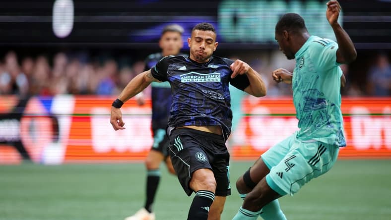Apr 23, 2023; Atlanta, Georgia, USA; Atlanta United forward Giorgos Giakoumakis (7) battles for the ball against Chicago Fire defender Carlos Teran (4) during the first half at Mercedes-Benz Stadium. Mandatory Credit: Brett Davis-USA TODAY Sports