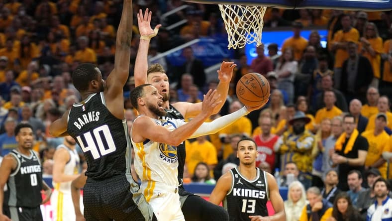 Apr 23, 2023; San Francisco, California, USA; Golden State Warriors guard Stephen Curry (center front) shoots against Sacramento Kings forward Harrison Barnes (40) and forward Domantas Sabonis (center back) during the fourth quarter of game four of the 2023 NBA playoffs at Chase Center. Mandatory Credit: Darren Yamashita-USA TODAY Sports
