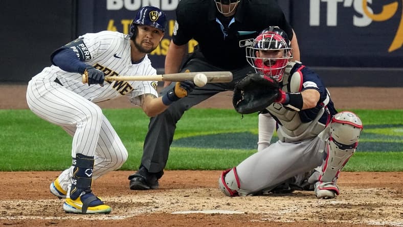 Apr 23, 2023; Milwaukee, Wisconsin, USA; Milwaukee Brewers center fielder Blake Perkins (16) bunts during the seventh inning of their game against the Boston Red Sox at American Family Field. Mandatory Credit: Mark Hoffman-USA TODAY Sports