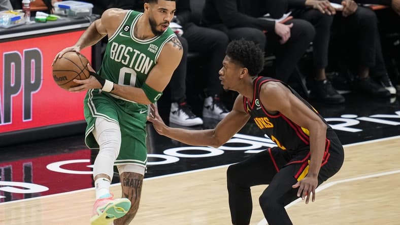 Apr 23, 2023; Atlanta, Georgia, USA; Boston Celtics forward Jayson Tatum (0) controls the ball against Atlanta Hawks forward De'Andre Hunter (12) during the first quarter during game four of the 2023 NBA playoffs at State Farm Arena. Mandatory Credit: Dale Zanine-USA TODAY Sports
