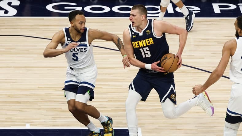 Apr 23, 2023; Minneapolis, Minnesota, USA; Denver Nuggets center Nikola Jokic (15) drives to the basket while Minnesota Timberwolves forward Kyle Anderson (5) defends during the first quarter of game four of the 2023 NBA Playoffs at Target Center. Mandatory Credit: Matt Krohn-USA TODAY Sports
