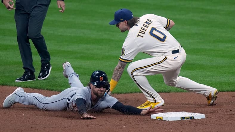 Apr 24, 2023; Milwaukee, Wisconsin, USA; Milwaukee Brewers second baseman Brice Turang (0) tags Detroit Tigers catcher Eric Haase (13) while trying to steal second base during the third inning at American Family Field. Mandatory Credit: Mark Hoffman-USA TODAY Sports