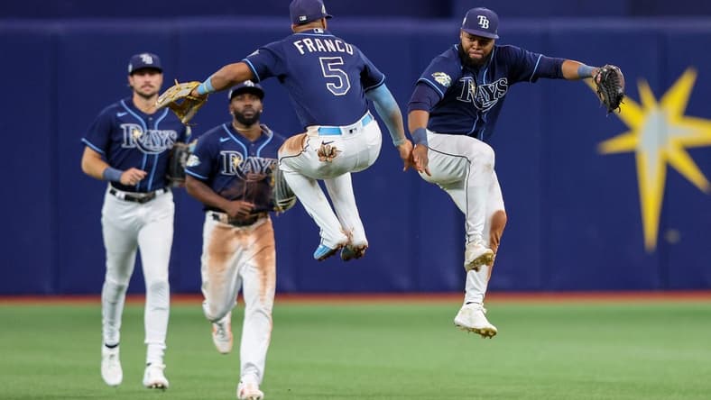 Apr 24, 2023; St. Petersburg, Florida, USA;  Tampa Bay Rays shortstop Wander Franco (5) and Tampa Bay Rays center fielder Manuel Margot (13) celebrate after beating the Houston Astros at Tropicana Field. Mandatory Credit: Nathan Ray Seebeck-USA TODAY Sports