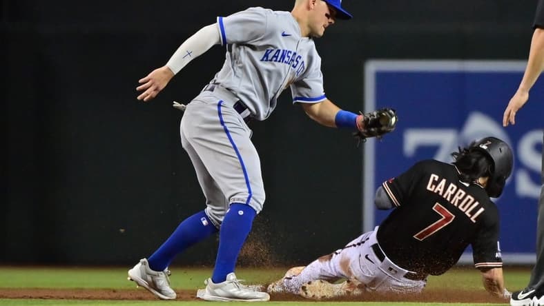 Apr 24, 2023; Phoenix, Arizona, USA; Arizona Diamondbacks left fielder Corbin Carroll (7) steals second base on Kansas City Royals second baseman Michael Massey (19) in the third inning at Chase Field. Mandatory Credit: Matt Kartozian-USA TODAY Sports