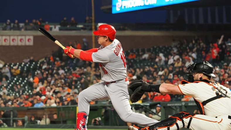 Apr 24, 2023; San Francisco, California, USA; St. Louis Cardinals designated hitter Nolan Gorman (16) hits a single ahead of San Francisco Giants catcher Joey Bart (21) during the sixth inning at Oracle Park. Mandatory Credit: Kelley L Cox-USA TODAY Sports