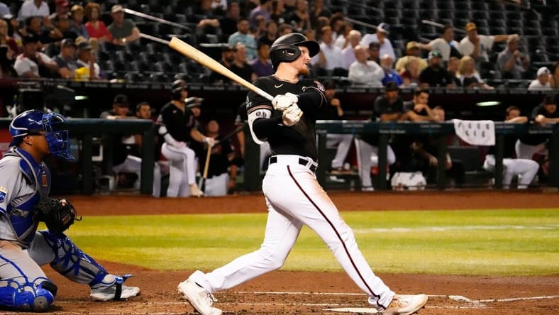 Apr 24, 2023; Phoenix, AZ, USA;  Arizona Diamondbacks Pavin Smith (26) hits an RBI-single against the Kansas City Royals in the third inning at Chase Field. Mandatory Credit: Rob Schumacher-Arizona Republic

Mlb Royals At D Backs