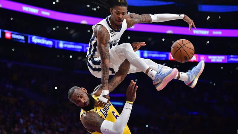 Apr 24, 2023; Los Angeles, California, USA; Memphis Grizzlies guard Ja Morant (12) collides with Los Angeles Lakers forward LeBron James (6) while moving to the basket during the second half in game four of the 2023 NBA playoffs at Crypto.com Arena. Mandatory Credit: Gary A. Vasquez-USA TODAY Sports