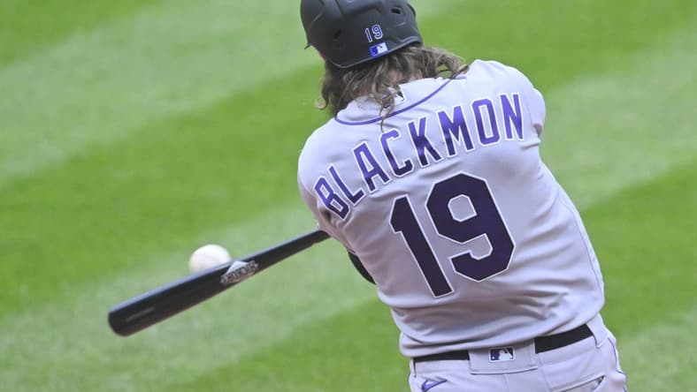 Apr 25, 2023; Cleveland, Ohio, USA; Colorado Rockies right fielder Charlie Blackmon (19) hits an RBI double during the second inning against the Cleveland Guardians at Progressive Field. Mandatory Credit: David Richard-USA TODAY Sports