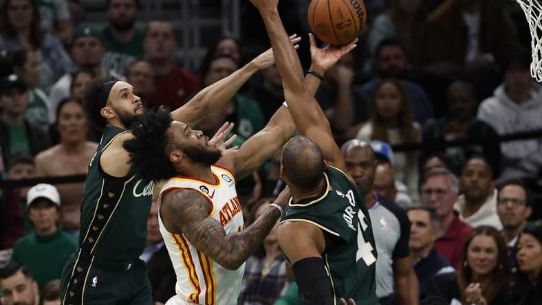 Apr 25, 2023; Boston, Massachusetts, USA; Atlanta Hawks forward Saddiq Bey (41) goes between Boston Celtics center Al Horford (42) and guard Derrick White (9) during the second quarter of game five of the 2023 NBA playoffs at TD Garden. Mandatory Credit: Winslow Townson-USA TODAY Sports
