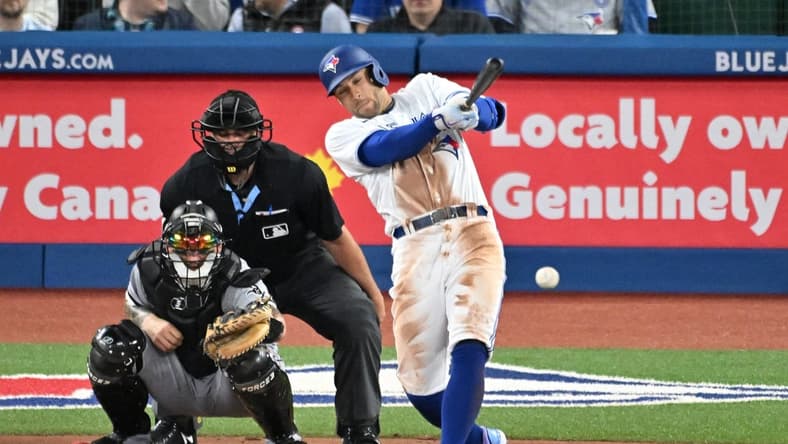 Apr 25, 2023; Toronto, Ontario, CAN;  Toronto Blue Jays right fielder George Springer (4) hits a single against the Chicago White Sox in the fourth inning at Rogers Centre. Mandatory Credit: Dan Hamilton-USA TODAY Sports