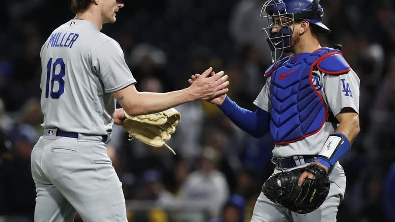 Apr 25, 2023; Pittsburgh, Pennsylvania, USA;  Los Angeles Dodgers relief pitcher Shelby Miller (18) and catcher Austin Barnes (15) shake hands after defeating the Pittsburgh Pirates at PNC Park. Los Angeles won 8-7. Mandatory Credit: Charles LeClaire-USA TODAY Sports