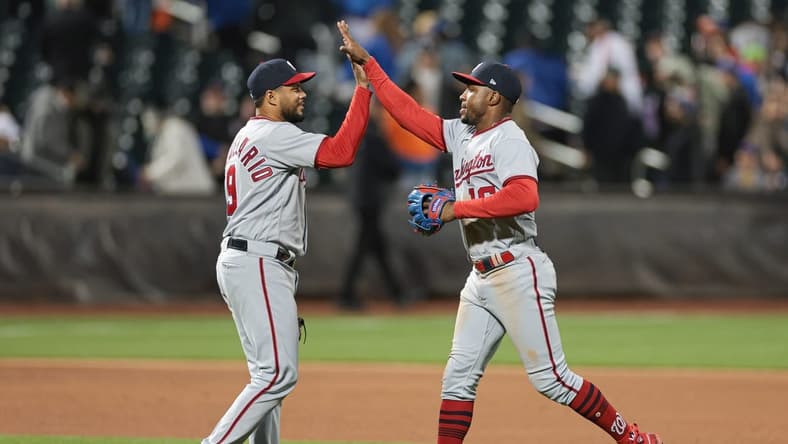 Apr 25, 2023; New York City, New York, USA;  Washington Nationals third baseman Jeimer Candelario (9) and center fielder Victor Robles (16) high five after the game against the New York Mets at Citi Field. Mandatory Credit: Vincent Carchietta-USA TODAY Sports
