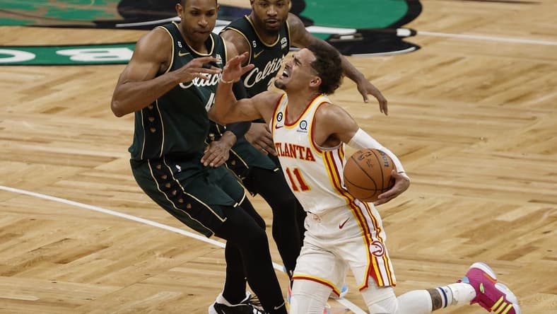 Apr 25, 2023; Boston, Massachusetts, USA; Atlanta Hawks guard Trae Young (11) gets fouled by Boston Celtics center Al Horford (42) during the fourth quarter of game five of the 2023 NBA playoffs at TD Garden. Mandatory Credit: Winslow Townson-USA TODAY Sports