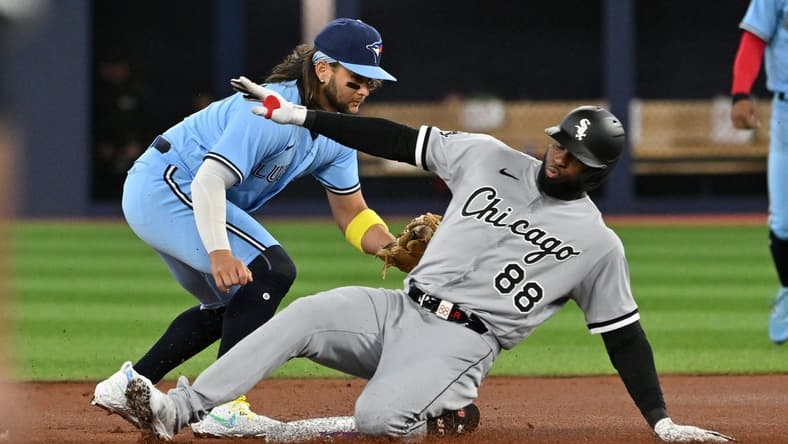 Apr 26, 2023; Toronto, Ontario, CAN;  Chicago White Sox center fielder Luis Robert Jr. (88) is tagged out at second base by Toronto Blue Jays shortstop Bo Bichette (11) in the first inning at Rogers Centre. Mandatory Credit: Dan Hamilton-USA TODAY Sports