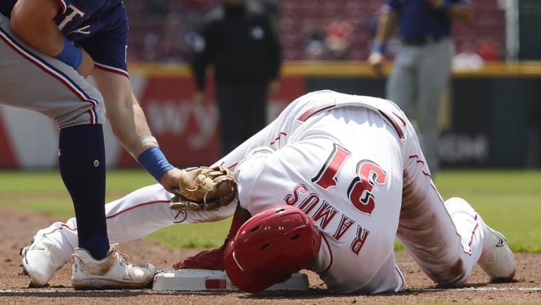 Apr 26, 2023; Cincinnati, Ohio, USA; Cincinnati Reds right fielder Henry Ramos (31) slides safely into third base for an RBI triple against the Texas Rangers during the second inning at Great American Ball Park. Mandatory Credit: David Kohl-USA TODAY Sports