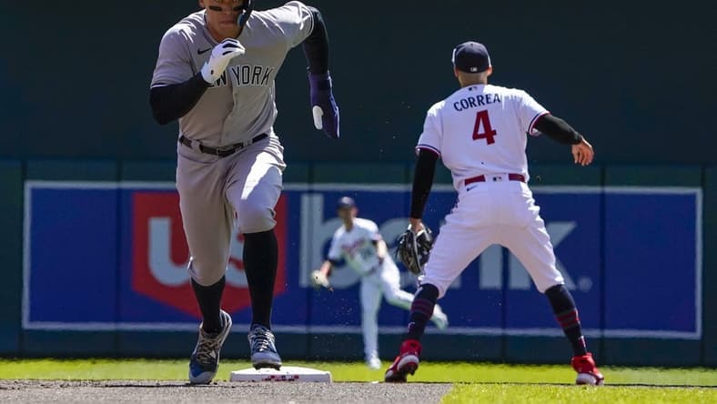 Apr 26, 2023; Minneapolis, Minnesota, USA; New York Yankees designated hitter Aaron Judge (99) runs to third on a sacrifice fly against the Minnesota Twins during the first inning at Target Field. Mandatory Credit: Nick Wosika-USA TODAY Sports
