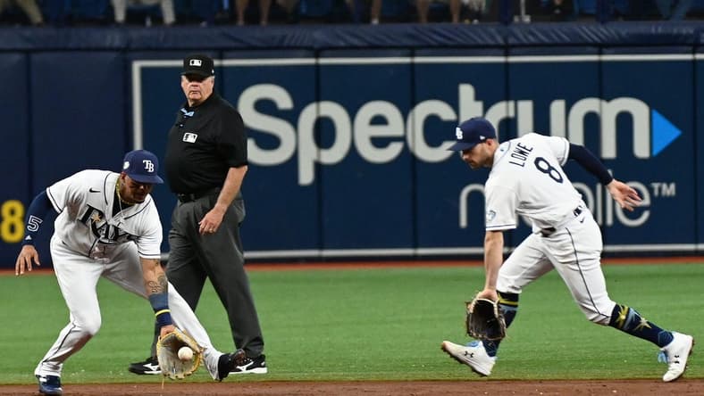 Apr 26, 2023; St. Petersburg, Florida, USA; Tampa Bay Rays shortstop Wander Franco (left) fields a ground ball in front of second baseman Brandon Lowe (8) in the third inning against the Houston Astros at Tropicana Field. Mandatory Credit: Jonathan Dyer-USA TODAY Sports