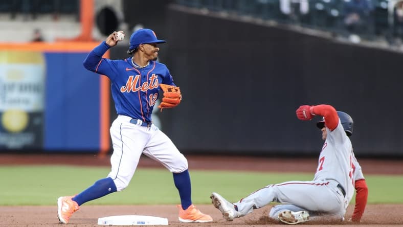 Apr 26, 2023; New York City, New York, USA; New York Mets shortstop Francisco Lindor (12) throws to first base over Washington Nationals left fielder Alex Call (17) while attempting to complete a double play in the first inning at Citi Field. Mandatory Credit: Wendell Cruz-USA TODAY Sports
