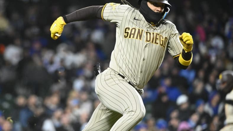 Apr 26, 2023; Chicago, Illinois, USA;  San Diego Padres right fielder Fernando Tatis Jr. (23) runs to first after he hits a two RBI single against the Chicago Cubs during the seventh inning at Wrigley Field. Mandatory Credit: Matt Marton-USA TODAY Sports