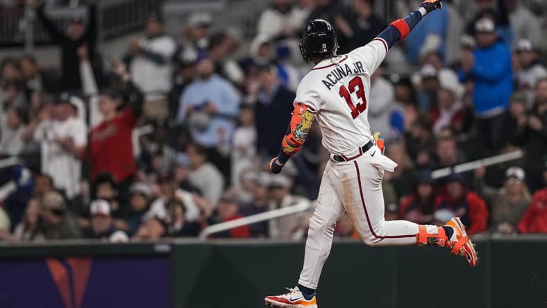 Apr 26, 2023; Cumberland, Georgia, USA;  Atlanta Braves right fielder Ronald Acuna Jr. (13) reacts after hitting a home run against the Miami Marlins during the sixth inning at Truist Park. Mandatory Credit: Dale Zanine-USA TODAY Sports