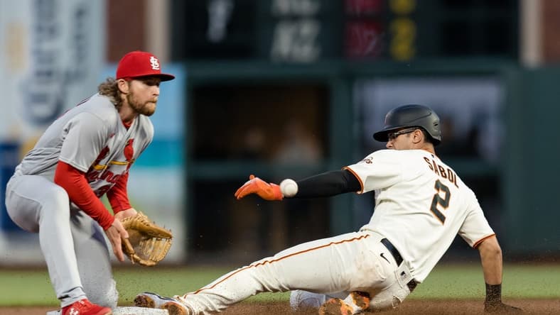 Apr 26, 2023; San Francisco, California, USA; St. Louis Cardinals second baseman Brendan Donovan (33) awaits the ball as San Francisco Giants catcher Blake Sabol (2) steals second base during the fourth inning at Oracle Park. Mandatory Credit: John Hefti-USA TODAY Sports