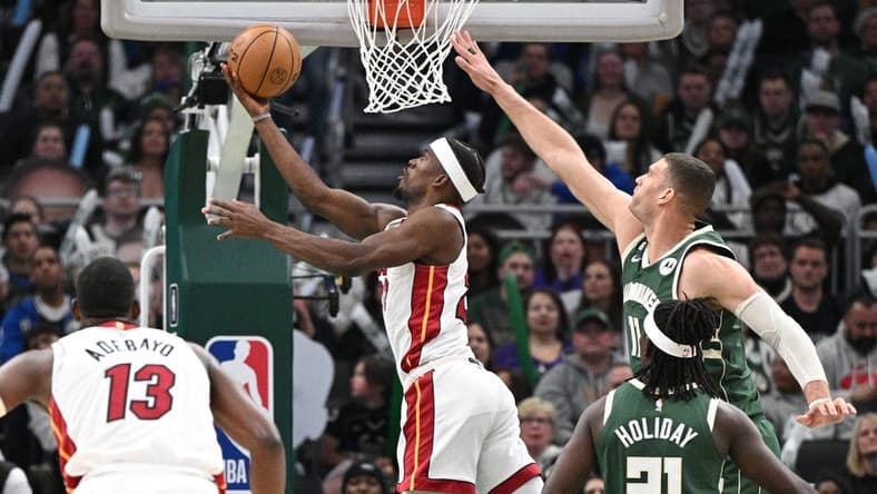 Apr 26, 2023; Milwaukee, Wisconsin, USA; Miami Heat forward Jimmy Butler (22) shoots the ball against Milwaukee Bucks center Brook Lopez (11)during game five of the 2023 NBA Playoffs at Fiserv Forum. Mandatory Credit: Michael McLoone-USA TODAY Sports