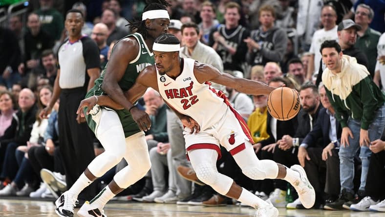 Apr 26, 2023; Milwaukee, Wisconsin, USA; Miami Heat forward Jimmy Butler (22) drives against Milwaukee Bucks guard Jrue Holiday (21) during game five of the 2023 NBA Playoffs at Fiserv Forum. Mandatory Credit: Michael McLoone-USA TODAY Sports