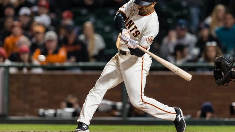 Apr 26, 2023; San Francisco, California, USA; San Francisco Giants first baseman LaMonte Wade Jr. (31) hits an RBI triple against the St. Louis Cardinals during the eighth inning at Oracle Park. Mandatory Credit: John Hefti-USA TODAY Sports