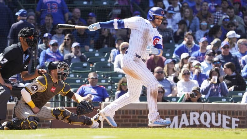 Apr 27, 2023; Chicago, Illinois, USA; Chicago Cubs left fielder Ian Happ (8) hits a RBI single against the San Diego Padres during the fifth inning at Wrigley Field. Mandatory Credit: David Banks-USA TODAY Sports