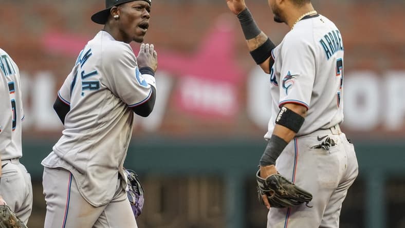 Apr 27, 2023; Cumberland, Georgia, USA; Miami Marlins center fielder Jazz Chisholm Jr. (2) reacts with second baseman Luis Arraez (3) after defeating the Atlanta Braves at Truist Park. Mandatory Credit: Dale Zanine-USA TODAY Sports