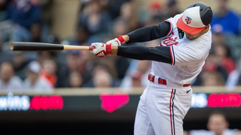 Apr 27, 2023; Minneapolis, Minnesota, USA; Minnesota Twins left fielder Trevor Larnach (9) hits an RBI single in the first inning against the Kansas City Royals at Target Field. Mandatory Credit: Jesse Johnson-USA TODAY Sports