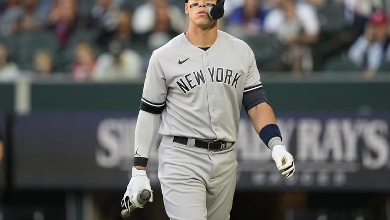 Apr 27, 2023; Arlington, Texas, USA; New York Yankees right fielder Aaron Judge (99) reacts after striking out against the Texas Rangers during the first inning at Globe Life Field. Mandatory Credit: Jim Cowsert-USA TODAY Sports