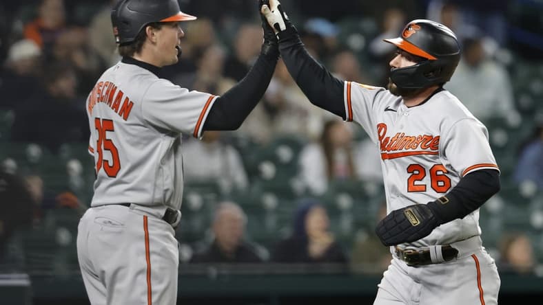 Apr 27, 2023; Detroit, Michigan, USA; Baltimore Orioles left fielder Ryan McKenna (26) receives congratulations from catcher Adley Rutschman (35) after scoring in the seventh inning against the Detroit Tigers at Comerica Park. Mandatory Credit: Rick Osentoski-USA TODAY Sports