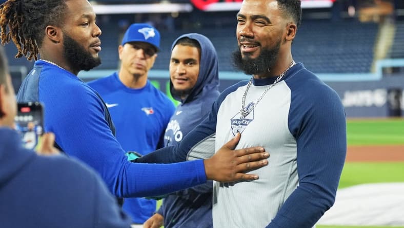 Apr 28, 2023; Toronto, Ontario, CAN; Seattle Mariners right fielder Teoscar Hernandez (right) greets Toronto Blue Jays first baseman Vladimir Guerrero Jr. (left) during batting practice prior to their game at Rogers Centre. Mandatory Credit: Nick Turchiaro-USA TODAY Sports