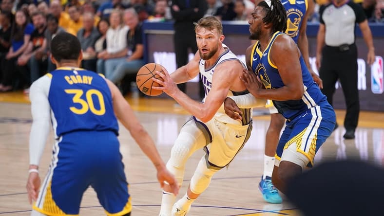 Apr 28, 2023; San Francisco, California, USA; Sacramento Kings forward Domantas Sabonis (10) holds onto the ball next to Golden State Warriors forward Kevon Looney (5) in the first quarter during game six of the 2023 NBA playoffs at the Chase Center. Mandatory Credit: Cary Edmondson-USA TODAY Sports