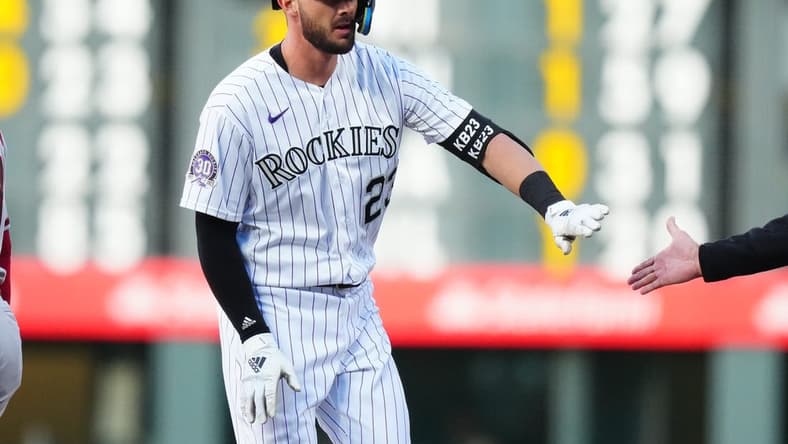 Apr 28, 2023; Denver, Colorado, USA; Colorado Rockies right fielder Kris Bryant (23) reacts following his single in the first inning the Arizona Diamondbacks at Coors Field. Mandatory Credit: Ron Chenoy-USA TODAY Sports