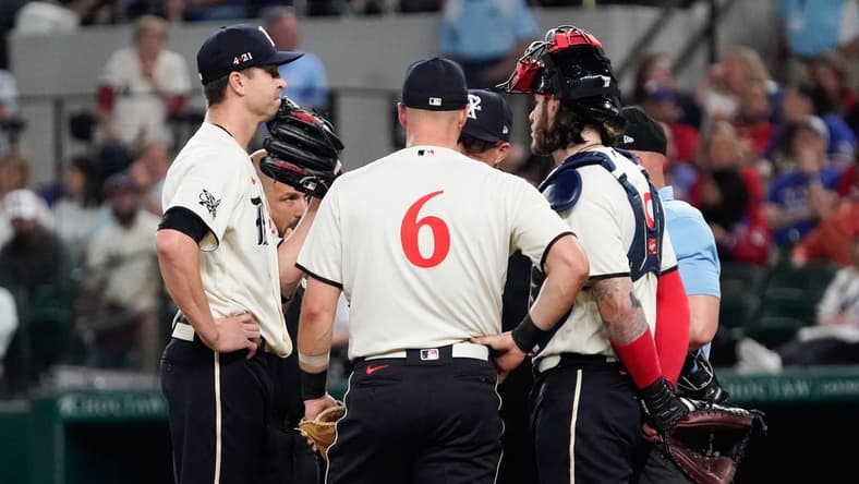 Apr 28, 2023; Arlington, Texas, USA; Texas Rangers starting pitcher Jacob deGrom (48) is visited on the mound by teammates and pitching coach pitching coach Mike Maddux (31) before leaving the game in the fourth inning against the New York Yankees at Globe Life Field. Mandatory Credit: Raymond Carlin III-USA TODAY Sports
