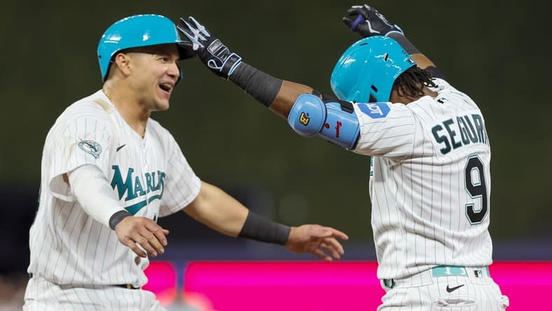 Apr 28, 2023; Miami, Florida, USA; Miami Marlins third baseman Jean Segura (9) celebrates with right fielder Avisail Garcia (24) after hitting a walk-off single during the ninth inning against the Chicago Cubs at loanDepot Park. Mandatory Credit: Sam Navarro-USA TODAY Sports