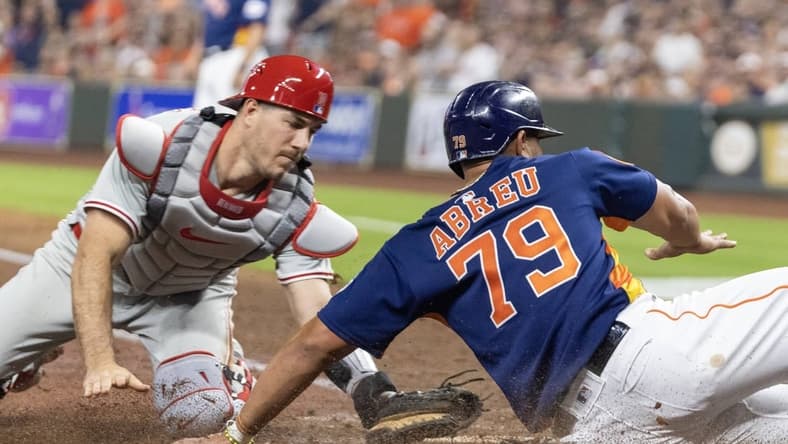 Apr 28, 2023; Houston, Texas, USA; Houston Astros first baseman Jose Abreu (79) is tagged out at home plate by Philadelphia Phillies catcher J.T. Realmuto (10) in the fifth inning at Minute Maid Park. Mandatory Credit: Thomas Shea-USA TODAY Sports