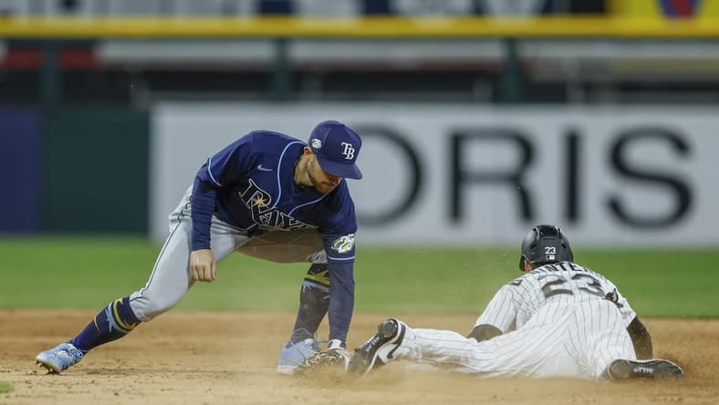 Apr 28, 2023; Chicago, Illinois, USA; Chicago White Sox left fielder Andrew Benintendi (23) steals second base against Tampa Bay Rays second baseman Brandon Lowe (8) during the seventh inning at Guaranteed Rate Field. Mandatory Credit: Kamil Krzaczynski-USA TODAY Sports