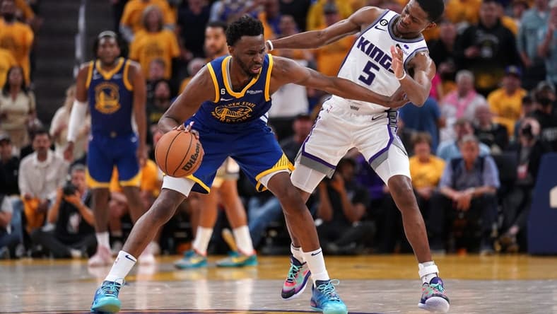Apr 28, 2023; San Francisco, California, USA; Golden State Warriors forward Andrew Wiggins (22) dribbles the ball next to Sacramento Kings guard De'Aaron Fox (5) in the third quarter during game six of the 2023 NBA playoffs at the Chase Center. Mandatory Credit: Cary Edmondson-USA TODAY Sports
