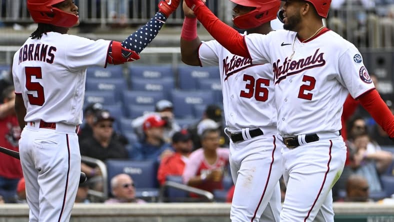 Apr 29, 2023; Washington, District of Columbia, USA; Washington Nationals second baseman Luis Garcia (2) and left fielder Stone Garrett (36) are congratulated by shortstop CJ Abrams (5) after scoring against the Pittsburgh Pirates during the fourth inning at Nationals Park. Mandatory Credit: Brad Mills-USA TODAY Sports