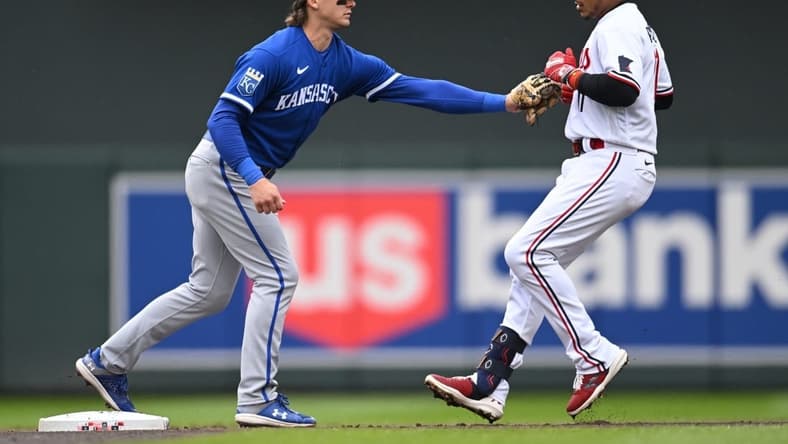 Apr 29, 2023; Minneapolis, Minnesota, USA; Kansas City Royals shortstop Bobby Witt Jr. (7) tags out Minnesota Twins second baseman Jorge Polanco (11) at second base during the first inning at Target Field. Mandatory Credit: Jeffrey Becker-USA TODAY Sports